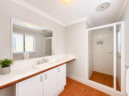 a white bathroom with a sink and a mirror at Longer Days at Halcyon Daze in Dunsborough