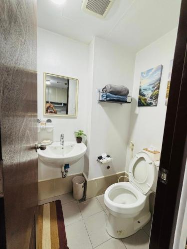 a bathroom with a toilet and a sink at The Tranquil Nook in Mandaue City
