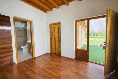 an empty room with an open door and a bathroom at Arhat Resort in Deskit