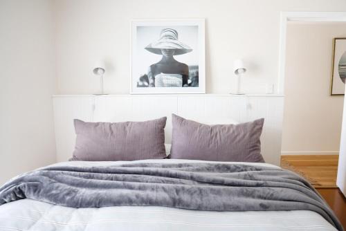 a bedroom with a bed with a hat on it at 'The Perch' - Central location in Robe, park your car and walk to everything in Robe