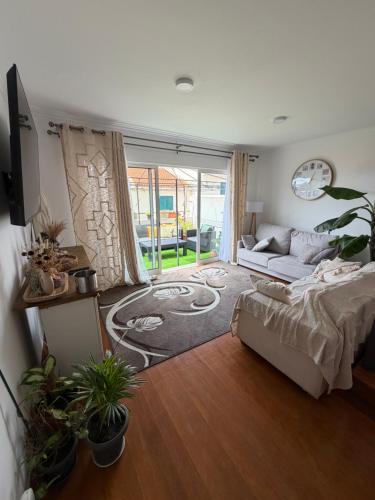 a living room with a bed and a couch at LandS in Caniço