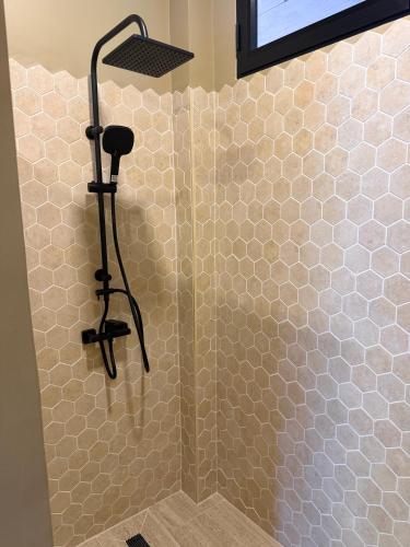 a shower with a shower head in a bathroom at Secret Cottages Chaweng Noi in Koh Samui