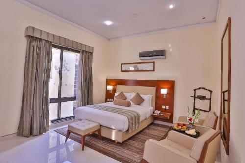 a bedroom with a large bed and a window at Avari Boutique Multan in Multan