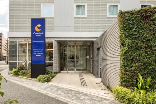 a building with a sign in front of it at Comfort Hotel ERA Tokyo Higashi Kanda in Tokyo