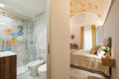 a bathroom with a bed and a shower and a toilet at Celine Dimora e Suite in Copertino