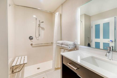 a white bathroom with a sink and a shower at Cambria Hotel Copper Mountain in Frisco