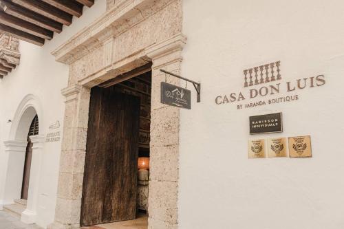 a door to a building with a sign on it at Hotel Casa Don Luis by Faranda Boutique, a member of Radisson Individuals in Cartagena de Indias