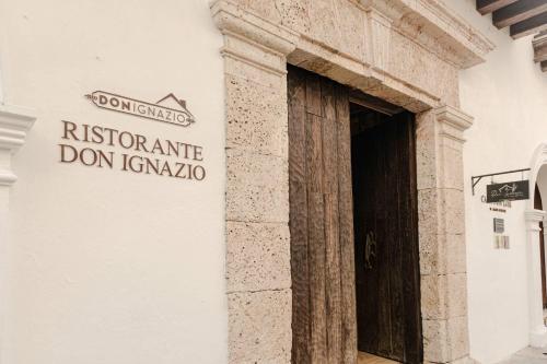 a sign on the side of a building with a door at Hotel Casa Don Luis by Faranda Boutique, a member of Radisson Individuals in Cartagena de Indias