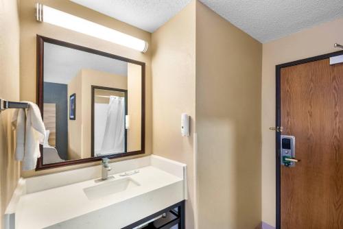 a bathroom with a sink and a mirror at Quality Inn Fairfield in Fairfield