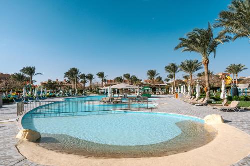 a large swimming pool at a resort with palm trees at Sentido Akassia Beach Resort in Quseir