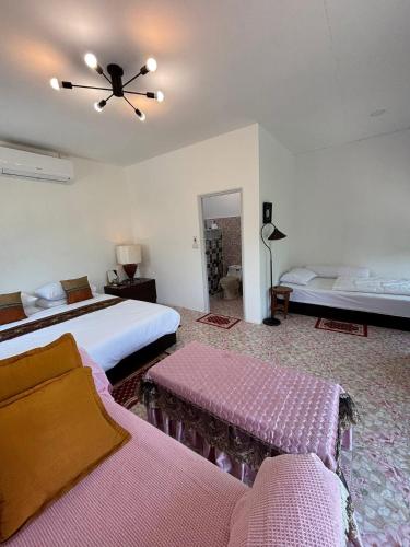 a bedroom with two beds and a ceiling fan at ฮิมฝาย โฮมสเตย์ บึงกาฬ in Ban Nong Khang Kha