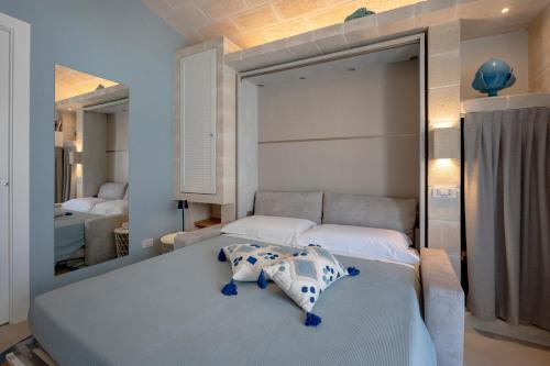 a bedroom with two beds and a mirror at Dimora Sofia, Charming House in Savelletri di Fasano