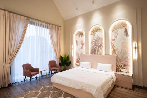 a bedroom with a bed and a table and chairs at Sukoon Luxury Stay in Amritsar