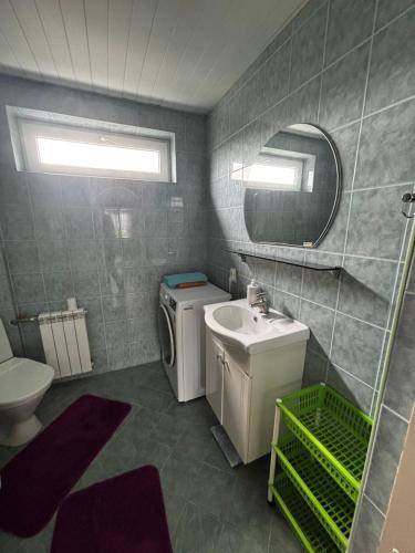a bathroom with a sink and a toilet and a mirror at Mugavustega avar perekorter 3toaline in Võru