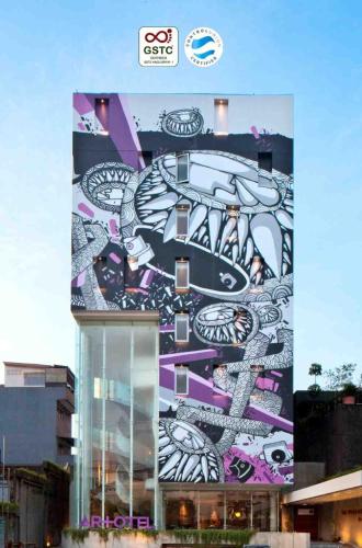 a building with a mural on the side of it at ARTOTEL Thamrin Jakarta in Jakarta