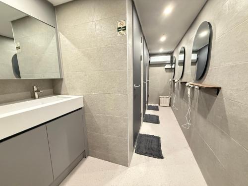 a bathroom with a sink and a mirror at Hostel K wave Only Female Hongdae in Seoul