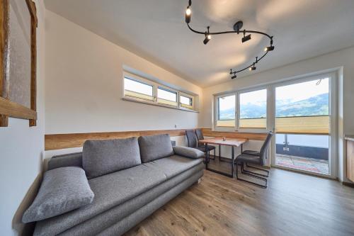 a living room with a couch and a table at Apartment Alpenstyle Ennstal in Aich