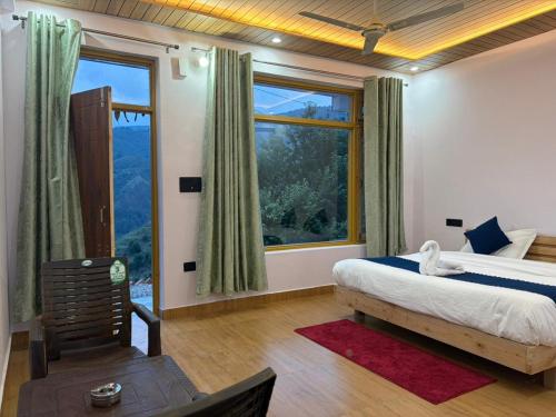 a bedroom with a bed and a large window at Pahadi Aangan Chakrata in Kailāna