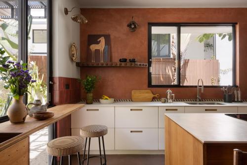 a kitchen with a sink and a counter with stools at CASA FRIDA by DW in San Juan