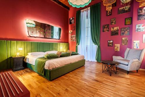 a bedroom with a bed and a chair at Palazzo San Fedele - Como Suites in Como