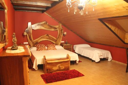 a attic bedroom with two beds and a chandelier at O Lar da Avoa in Cambados