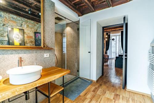 a bathroom with a sink and a mirror at Palazzo San Fedele - Como Suites in Como