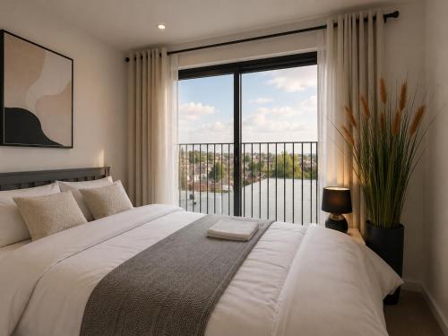 a bedroom with a large bed and a large window at Luxurious & Elegant 6-Bed House in Barnet