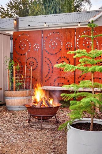 a fire pit in a garden with a fence at Styled Entertainer only mins from CBD in Bendigo