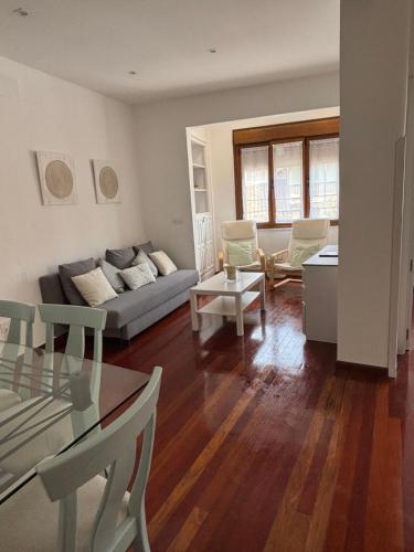 a living room with a couch and a table at Apartamento Arena in Ribadesella