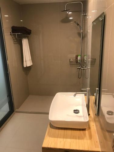 a bathroom with a white sink and a shower at Zukara Maldives in Thoddoo