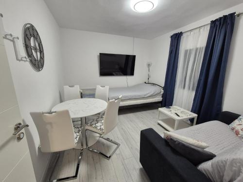 a small living room with a table and a bed at Šućur holiday home in Preko