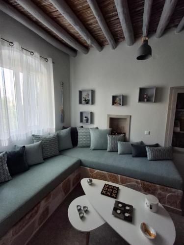 a living room with a couch and a table at Traditional house in the heart of Naxos in Dhamariónas