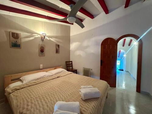 a bedroom with a large bed with two towels on it at Casa De Pueblo Raval in Teulada