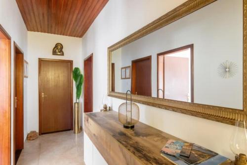 a bathroom with a large mirror on the wall at Apartments Dare & Piccolo in Kaštela