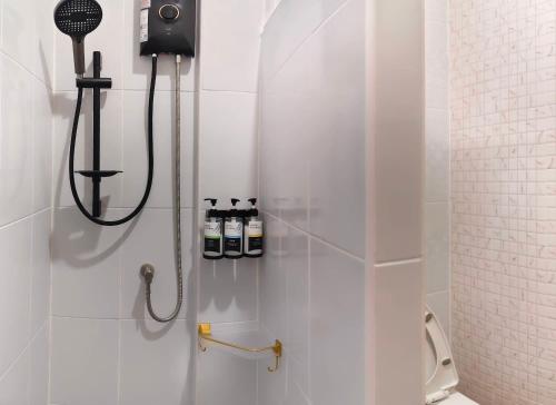 a bathroom with a shower with three bottles on the wall at บ้านออมPool villa บางแสน sin in Ban Bang Saen (1)