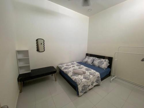 a small bedroom with a bed and a chair at Rumah Inap Nik Atik in Cukai