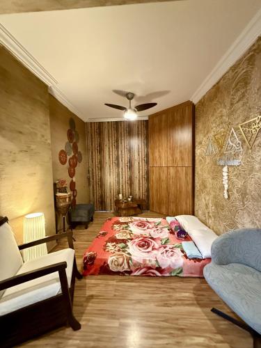 a bedroom with a large bed and a couch at Apartamento Praia da Costa in Vila Velha