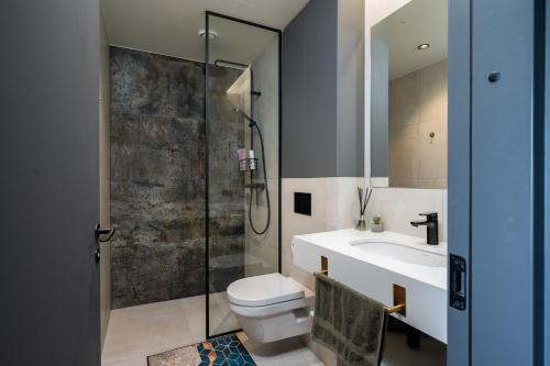 a bathroom with a shower and a toilet and a sink at New apartment in Karlova in Tartu