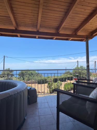 a balcony with a view of the ocean at La Pietra Maisonettes in Neokhórion