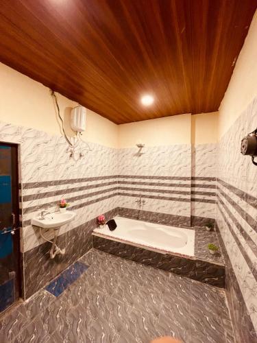 a bathroom with a tub and a sink at Hotel Sky Palace Airport Zone in Hyderabad