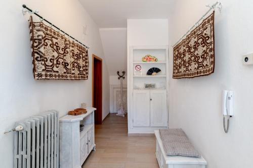 a living room with a radiator and a hallway at De Addis Guest House in Aggius
