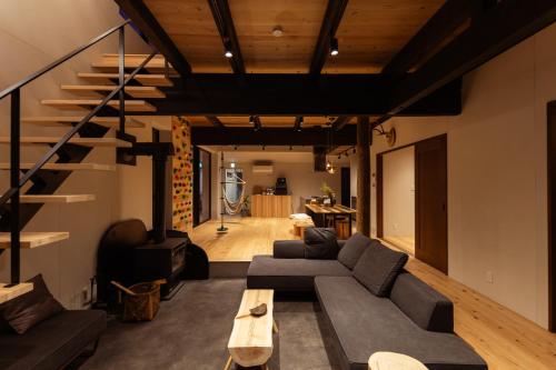 a living room with a couch and a table at ひのまきbase-暖- in Uda