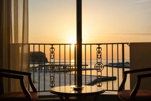 a room with a balcony with a table and chairs at Rembrandt Resort Shiretoko in Shari