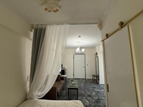 a living room with a curtain and a couch at Boutique Sea & Garden in Vari