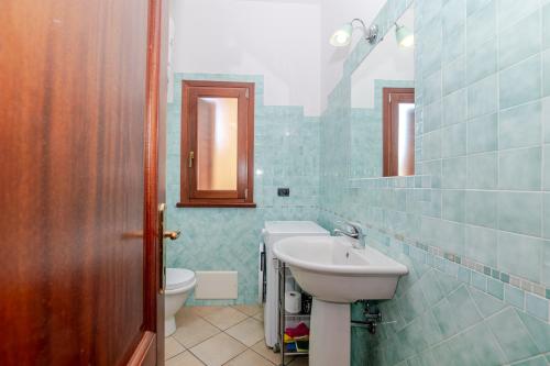 a bathroom with a sink and a toilet at Villa Oleandro - 2349447 in San Teodoro