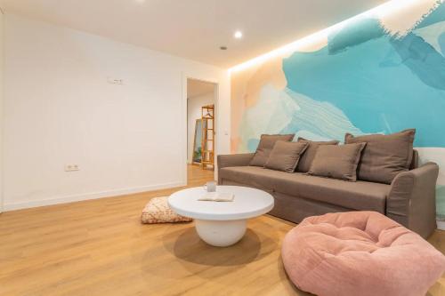 a living room with a couch and a table at MAAR Suites Cotillo in El Cotillo