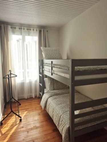 a bedroom with two bunk beds and a window at Kergoat in Carhaix-Plouguer