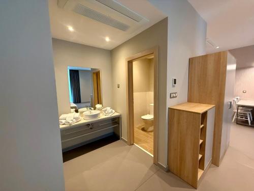 a bathroom with a sink and a toilet at Romance Hotel and Family Suites in Saints Constantine and Helena