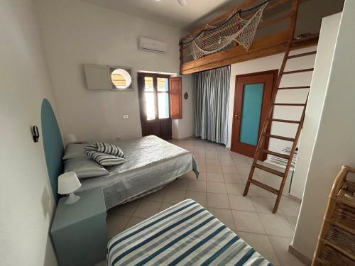 a bedroom with a bunk bed and a ladder at Melania Home II in Filicudi