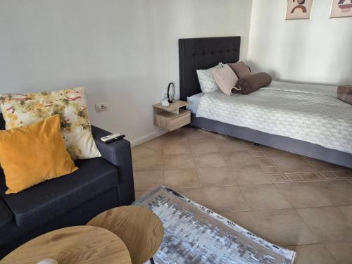a living room with a couch and a bed at Eve Santa Marina Studios - sea, pools, relax in Sozopol